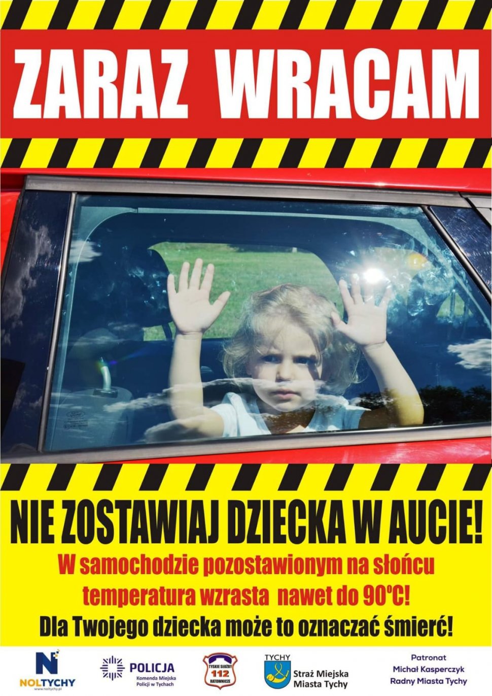 Na zdjęciu widoczny plakat, na nim dziewczynka zamknięta w samochodzie oraz napis" Nie zostawiaj dziecka w aucie , w samochodzie pozostawionym na słońcu temperatura wzrasta nawet do 90  stopni Celsjusza. Dla twojego dziecka może to oznaczać śmierć".