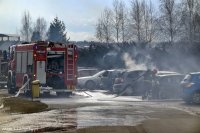 Obrazek przedstawia wóz strażacki oraz strażaków dogaszających pojazdy