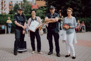 Policjanci, pomiędzy nimi dwie kobiety.