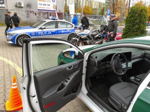 Widoczny policjant obok motocykla , dalej radiowóz.