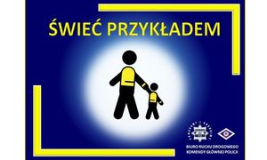 Napis &quot;Świeć Przykładem&quot;. Duża i mała postać graficzna trzyma się za rękę, ma założona kamizelkę odblaskową.