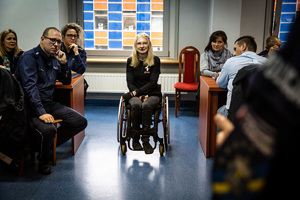 Zdjęcie. Pomieszczenie, w którym policjanci i inne osoby biorą udział w szkoleniu