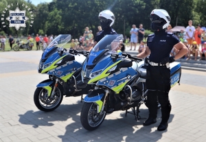 Na zdjęciu policjanci stojący obok dwóch policyjnych motocykli.