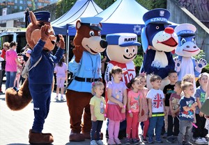 Na zdjęciu policyjne maskotki oraz maskotka Centrum Powiadamiania Ratunkowego 112 z dziećmi.