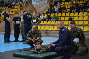 Na zdjęciu widać policjanta oraz uczestników 1. Międzypowiatowej Olimpiady Bezpieczeństwa.