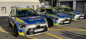 Kolorowe zdjęcie trzech oznakowanych radiowozów Policji.