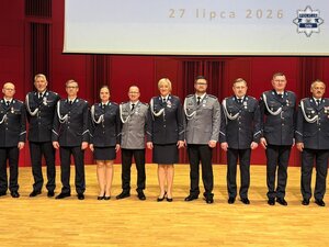 Umundurowani policjanci kadry kierowniczej stojący na scenie.